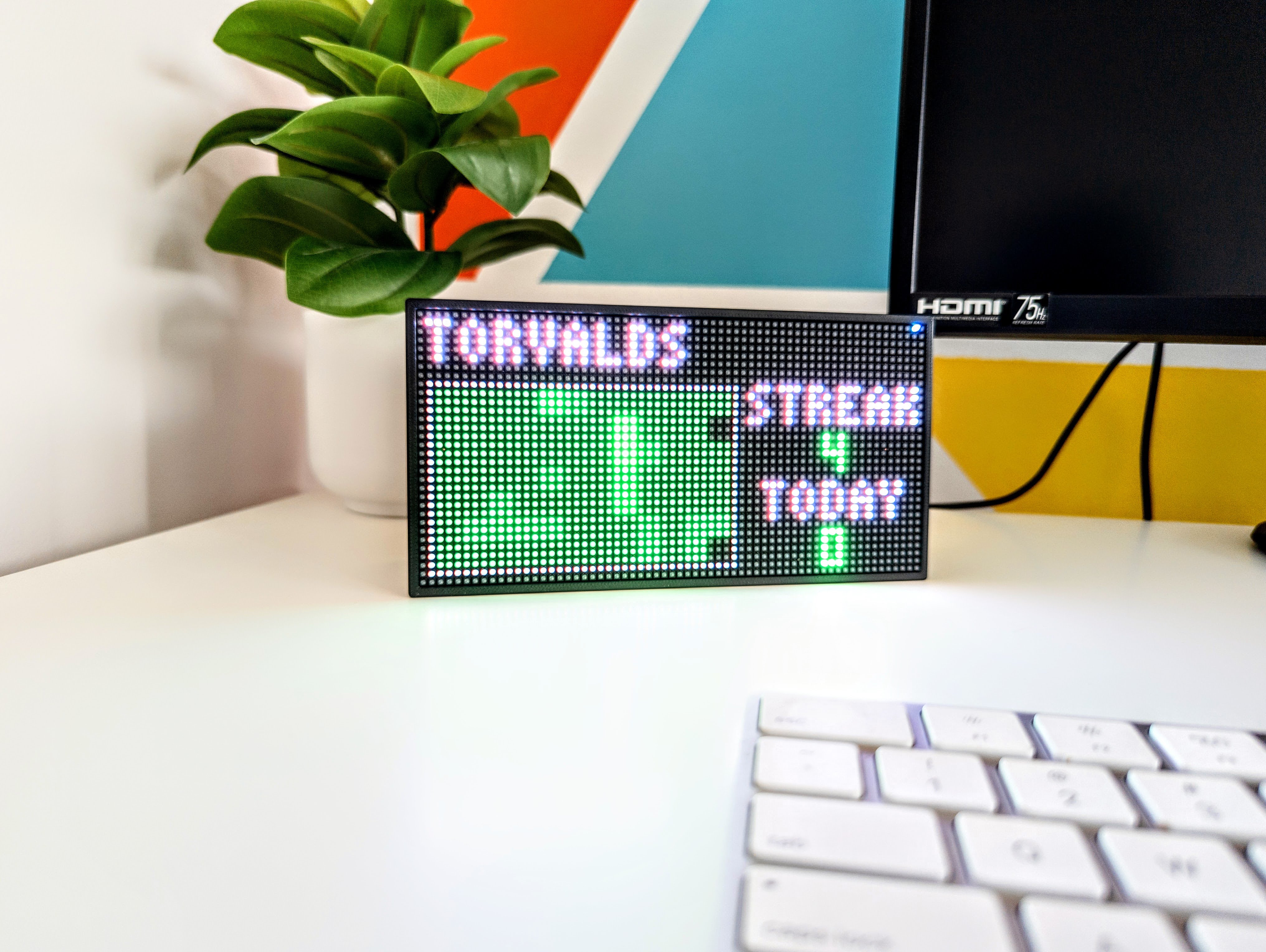GitGrid display on a desk showing GitHub contributions